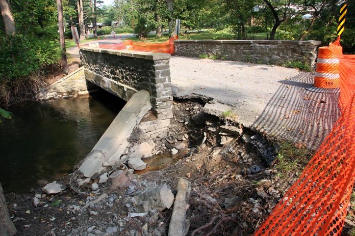 Stone bridge on Aspinwall with damaged road