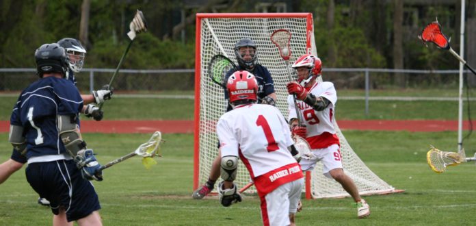 Pal Guerra (#1) completes a pass to Onam Guerra (#9) directly in front of the Wallkill net.